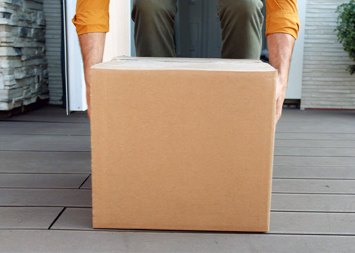 Ein Kunde, welcher ein Paket entgegennimmt. Es soll aufzeigen, dass man die Lieferung samt Rechnung erhält und keinerlei Risiken eingeht.